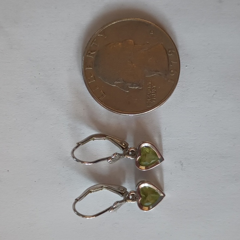 Genuine peridot heart dangle earrings in a white gold setting